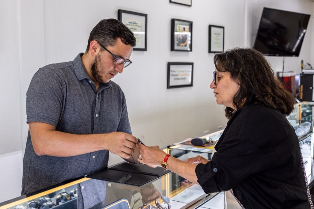 Prestige Watches staff helping a customer compare watches