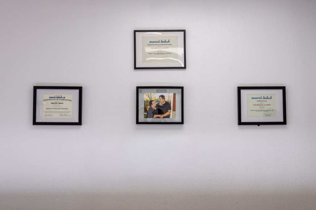 Prestige Watches & Jewelry certificates and family photo in the showroom